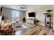 Bright living room with hardwood floors, a modern ceiling fan, and sliding glass doors to patio at 10656 Hyde Corner Ave, Las Vegas, NV 89166