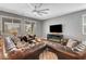 Spacious living room featuring leather sofas, hardwood floors, and a ceiling fan at 10656 Hyde Corner Ave, Las Vegas, NV 89166