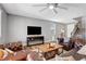 Comfortable living room featuring brown leather furniture, hardwood floors, and staircase access at 10656 Hyde Corner Ave, Las Vegas, NV 89166