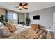Comfortable main bedroom with wood floors, fan, and access to a private balcony at 10656 Hyde Corner Ave, Las Vegas, NV 89166