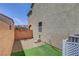 Low-maintenance side yard featuring artificial turf, gravel, and drought-tolerant plants, offering simple charm at 10656 Hyde Corner Ave, Las Vegas, NV 89166