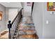 Elegant staircase with ornate banister and unique stone-look steps at 10656 Hyde Corner Ave, Las Vegas, NV 89166