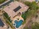 Wonderful aerial view of a property with a sparkling pool, patio area, putting green, and solar panels at 11 Knob Oak Dr, Henderson, NV 89052