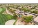 Panoramic aerial view showcasing a home with a sparkling pool and solar panels in a golf course community at 11 Knob Oak Dr, Henderson, NV 89052