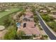 Aerial view of home with pool, solar panels, and golf course at 11 Knob Oak Dr, Henderson, NV 89052