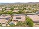 Sweeping aerial view of a neighborhood highlighting the home, mature trees, and golf course surroundings at 11 Knob Oak Dr, Henderson, NV 89052