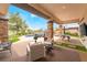 Spacious covered back patio overlooking a pool, manicured yard, and beautiful golf course at 11 Knob Oak Dr, Henderson, NV 89052