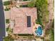 Overhead shot of a backyard with a kidney shaped pool, patio furniture, built in solar panels and manicured landscaping at 11 Knob Oak Dr, Henderson, NV 89052