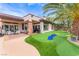 Beautiful backyard with putting green, patio, and outdoor seating, perfect for entertaining at 11 Knob Oak Dr, Henderson, NV 89052