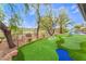 The gorgeous backyard has a custom putting green, pool and spa with mature trees at 11 Knob Oak Dr, Henderson, NV 89052