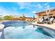 Stunning backyard oasis with pool, spa, seating areas, and mature landscaping for outdoor enjoyment at 11 Knob Oak Dr, Henderson, NV 89052