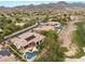Aerial view of a home's backyard featuring a pool, patio, and landscaped yard, backing up to a golf course at 11 Knob Oak Dr, Henderson, NV 89052