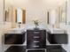 Modern bathroom with dual floating vanities, decorative mirrors and a central cabinet for storage at 11 Knob Oak Dr, Henderson, NV 89052
