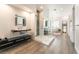 Modern bathroom featuring walk-in shower, floating vanity, and soaking tub in the background at 11 Knob Oak Dr, Henderson, NV 89052