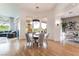 Formal dining room features a round glass table, modern chandelier, and views of outdoor living area at 11 Knob Oak Dr, Henderson, NV 89052