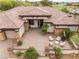 Stunning aerial view of a single-story home with mature trees, a three-car garage, and well-manicured landscaping at 11 Knob Oak Dr, Henderson, NV 89052