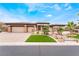 Charming single-story home with a three-car garage, well-manicured lawn and desert landscaping at 11 Knob Oak Dr, Henderson, NV 89052