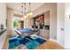 Bright game room features a pool table, pendant lighting, custom bar, and beautiful interior design at 11 Knob Oak Dr, Henderson, NV 89052