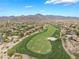 Scenic view of a golf course nestled within a desert community with homes and mountains in the background at 11 Knob Oak Dr, Henderson, NV 89052