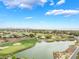 Picturesque aerial view of a golf course community featuring lush landscaping, serene ponds, and mountain views at 11 Knob Oak Dr, Henderson, NV 89052