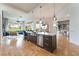 Open kitchen with stainless appliances, large island, breakfast bar, and view into the living room at 11 Knob Oak Dr, Henderson, NV 89052