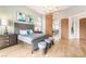Bright bedroom featuring a chandelier, hardwood floors, and ensuite at 11 Knob Oak Dr, Henderson, NV 89052