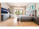 Bedroom showcasing chandelier, sliding glass doors to back yard, and hardwood floors at 11 Knob Oak Dr, Henderson, NV 89052