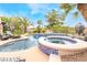 Beautiful backyard featuring a pool, spa, buddha water feature, and lush landscaping at 11 Knob Oak Dr, Henderson, NV 89052