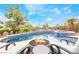 A relaxing backyard featuring a stunning pool with a spa, poolside seating, and lush landscaping at 11 Knob Oak Dr, Henderson, NV 89052