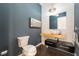 Stylish powder room with floating wood countertop sink, custom accent wall, and sleek fixtures at 11 Knob Oak Dr, Henderson, NV 89052