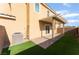 View of the home's backyard patio with brick floors and artificial grass at 1102 E Dorrell Ln, North Las Vegas, NV 89086