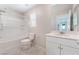 Bright bathroom with a white vanity, shower-tub combo, and neutral tile flooring at 1102 E Dorrell Ln, North Las Vegas, NV 89086