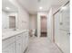 Bright bathroom featuring a double vanity, a walk-in shower and a door to the walk-in closet at 1102 E Dorrell Ln, North Las Vegas, NV 89086