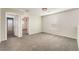 This bedroom offers neutral walls, carpet flooring, and a door leading to another room at 1102 E Dorrell Ln, North Las Vegas, NV 89086