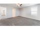 Bright bedroom featuring carpet, neutral walls, a ceiling fan, and view of the en-suite bathroom at 1102 E Dorrell Ln, North Las Vegas, NV 89086