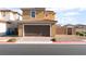 Charming two-story home with a brick driveway and two-car garage at 1102 E Dorrell Ln, North Las Vegas, NV 89086