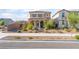 Charming two-story home featuring a covered front porch and well-maintained desert landscaping at 1102 E Dorrell Ln, North Las Vegas, NV 89086