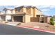 Two-story home with a brick driveway and a two-car garage at 1102 E Dorrell Ln, North Las Vegas, NV 89086