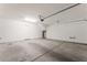 Spacious garage with concrete flooring and an automatic door opener at 1102 E Dorrell Ln, North Las Vegas, NV 89086