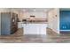 Modern kitchen with white cabinets, granite countertops, stainless steel appliances, and a center island at 1102 E Dorrell Ln, North Las Vegas, NV 89086