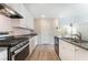 Kitchen featuring stainless steel oven range, granite countertops, white cabinets, and an open layout at 1102 E Dorrell Ln, North Las Vegas, NV 89086
