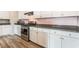 Modern kitchen with white cabinets, granite countertops, and stainless steel oven range at 1102 E Dorrell Ln, North Las Vegas, NV 89086