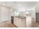 Open-concept kitchen island with granite countertop and stainless steel sink overlooks the spacious living area at 1102 E Dorrell Ln, North Las Vegas, NV 89086