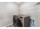 Laundry room featuring modern washer and dryer with overhead wire shelving at 1102 E Dorrell Ln, North Las Vegas, NV 89086