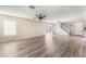 Spacious living room with laminate flooring, ceiling fan, and natural light, showcasing a modern design at 1102 E Dorrell Ln, North Las Vegas, NV 89086