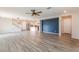 Open-concept living room with laminate flooring flowing into the kitchen, featuring a modern accent wall at 1102 E Dorrell Ln, North Las Vegas, NV 89086