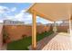 Covered patio with brick flooring, artificial grass, and a brick privacy wall at 1102 E Dorrell Ln, North Las Vegas, NV 89086