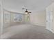 Spacious bedroom featuring plantation shutters, carpet and ceiling fan at 11056 Kilkerran Ct, Las Vegas, NV 89141