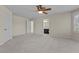 Spacious bedroom with plush carpeting, ceiling fan, and view to en suite bathroom at 11056 Kilkerran Ct, Las Vegas, NV 89141