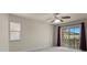Bedroom featuring a sliding glass door to a balcony with views of the surrounding landscape at 11056 Kilkerran Ct, Las Vegas, NV 89141